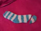 Blue and white stripped fuzzy sock with the toe cut 